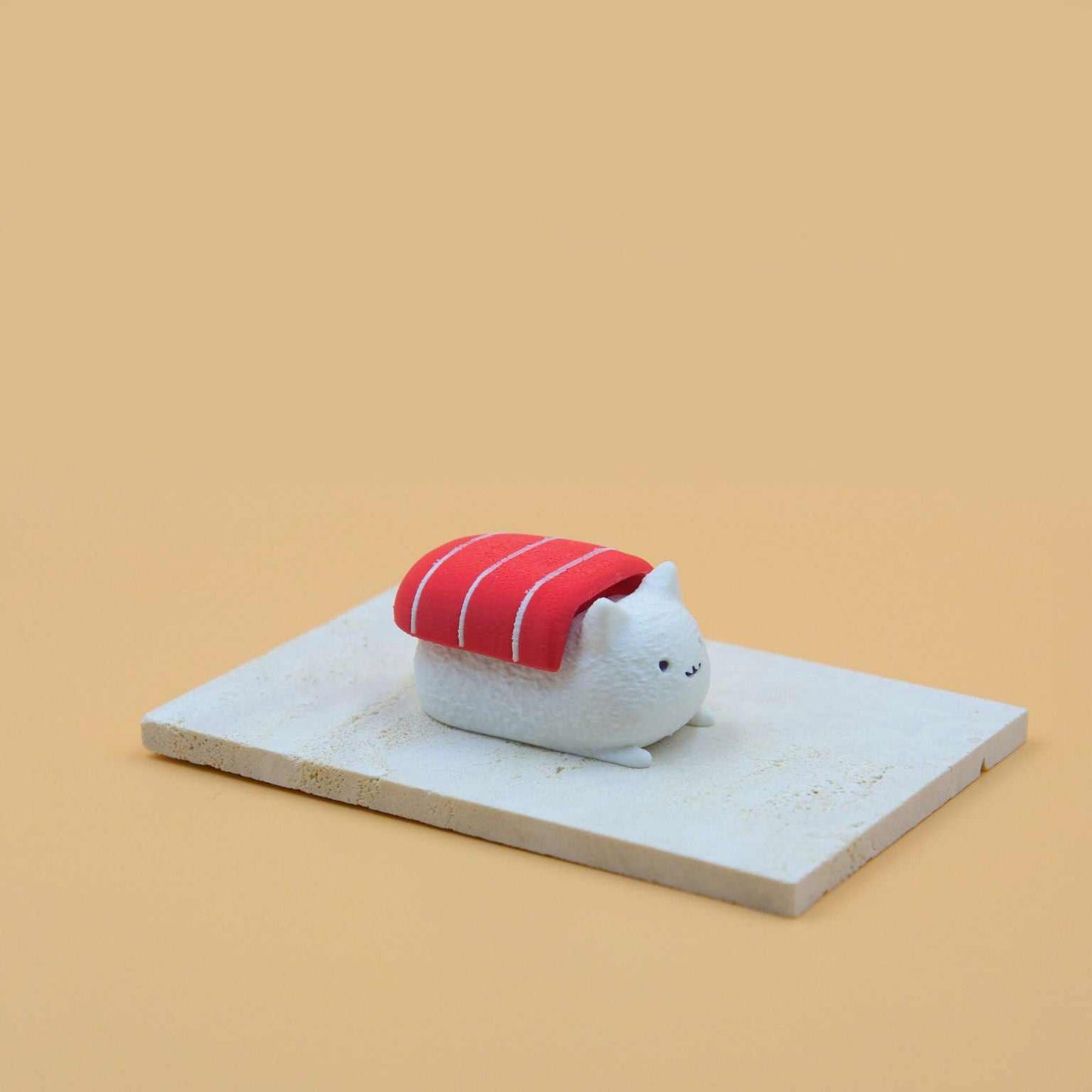 M.E.S.A. X Sushi Cat hand-finished 3D-printed tuna sushi cat figurines with red fish topping on beige display board