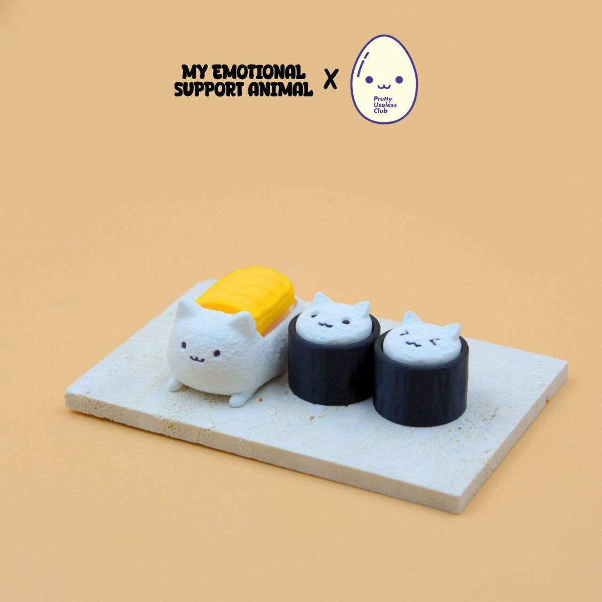 M.E.S.A. X Sushi Cat kiddo set of 3 hand-finished 3D-printed sushi cat keychains on a beige surface