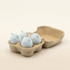Eggie Meow Clicky Set of four egg-shaped cat face fidget toys in a brown carton with perky ears and cute expressions.